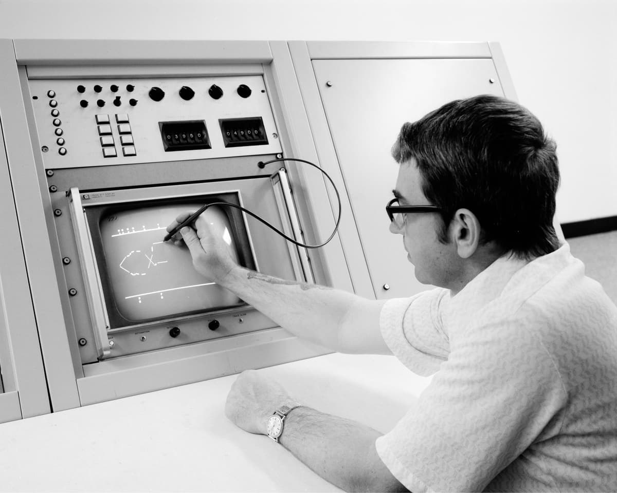 Man in glasses using computer stylus